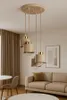 A modern living room with a beige sofa, a chair, and a coffee table, featuring a beige pendant light fixture hanging from the ceiling. Produktbild-Vorschau