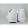 The back view of two white Adidas sneakers on a light gray textured surface. Anteprima dell’immagine prodotto