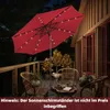 A red patio umbrella with solar LED lights is set up on a wooden deck at night, with wicker chairs and a small table. Anteprima dell’immagine prodotto