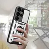 A hand holding a phone case with a ring holder, with a blurred indoor background. Produktbild-Vorschau