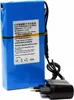 A blue rechargeable battery pack with a black charger. Produktbild-Vorschau
