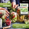 Hands are shown arranging dill in a glass jar filled with pickled vegetables and chili peppers, with other jars of pickled items in the background. Produktbild-Vorschau