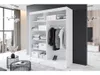 A modern bedroom with a large white wardrobe filled with clothes and storage boxes. A large window with a city view is visible in the background. Produktbild-Vorschau