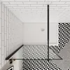 A top-down view of a modern bathroom shower area with geometric patterned tiles and a glass shower enclosure. Produktbild-Vorschau