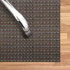 A close-up view of an office chair wheel resting on a woven mat on a wooden floor. Podgląd zdjęcia produktu