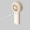 A close-up shot of a portable hand fan being charged via a USB cable. Anteprima dell’immagine prodotto