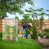 A woman and a child are in a garden with a greenhouse. Náhled obrázku produktu