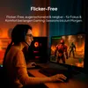 A woman wearing a headset is playing a video game on a computer monitor in a dimly lit room. Produktbild-Vorschau