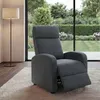 A dark gray recliner chair is placed on a light-colored rug in a living room with a large window overlooking a garden.