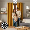 A family posing in a living room with yellow curtains. Produktbild-Vorschau