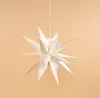 A white star-shaped lantern hangs against a plain orange background. Voir les images du produit
