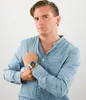 A man wearing a blue shirt and a watch. Produktbild-Vorschau