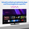 A television screen displaying a smart TV interface with various app icons and recommended content. Produktbild-Vorschau