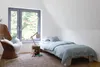 A cozy child's bedroom with a bed, chair, and window. Produktbild-Vorschau