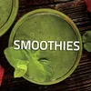 A top-down view of a green smoothie in a glass, with mint leaves and strawberries visible. Podgląd zdjęcia produktu