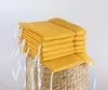 A stack of yellow cushions on a woven basket. Produktbild-Vorschau