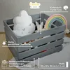 A grey wooden crate filled with children's toys, including a cloud-shaped pillow and a stuffed bunny, with a rainbow decoration. Produktbild-Vorschau