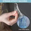 A hand is shown peeling off a clear adhesive hook from a backing, with an inset showing a bottle of water hanging from a similar hook. Produktbild-Vorschau