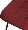 Close-up view of a red upholstered chair seat with tufted detailing and a black metal leg. Produktbild-Vorschau