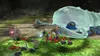A group of small creatures, called Pikmin, are gathered around a large, translucent, caterpillar-like creature in a cave-like environment. Produktbild-Vorschau