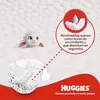 A cartoon sheep character is shown peeking out from a fluffy white surface, with a Huggies diaper and marketing text about the product's softness and absorbency. Náhľad obrázku produktu