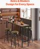 A bar table with stools in a room with a window and shelves of wine glasses. Produktbild-Vorschau