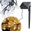 A string of solar-powered garden lights with clear, bubble-like bulbs and a separate solar panel unit. Náhľad obrázku produktu