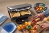 A sandwich toaster is shown in use with a person preparing ingredients for a salad. Produktbild-Vorschau