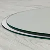 A close-up shot of the edge of a round mirror with a silver frame, resting on a light wooden floor. Produktbild-Vorschau