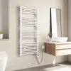 A white electric towel radiator mounted on a light beige wall in a modern bathroom setting. Podgląd zdjęcia produktu