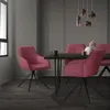 A dining room scene with pink chairs around a dark table, under pendant lights. Produktbild-Vorschau
