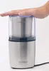 A hand pressing down on the lid of a silver coffee grinder. Anteprima dell’immagine prodotto