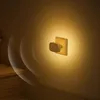 A night light with a motion sensor plugged into a wall outlet on a staircase. Produktbild-Vorschau
