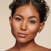 Close-up portrait of a woman's face, with a neutral expression and looking directly at the camera. Produktbild-Vorschau