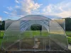 A greenhouse structure in an outdoor setting with a cloudy sky. Produktbild-Vorschau
