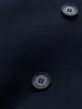 A close-up of two dark blue buttons on a dark blue fabric. Anteprima dell’immagine prodotto