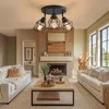 A modern living room with a fireplace, two white sofas, and a coffee table, featuring a black ceiling light. Produktbild-Vorschau