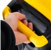 A hand is holding a yellow handle of a black and yellow object. Anteprima dell’immagine prodotto