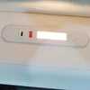 A close-up view of a white light bar with integrated USB-C port and a red switch. Produktbild-Vorschau