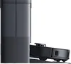 A robot vacuum cleaner docking with its charging station. Voir les images du produit