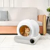 A modern cat litter box with a cat inside, placed on a rug in a living room setting with a sofa in the background. Anteprima dell’immagine prodotto