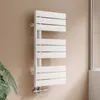 A white designer radiator mounted on a beige wall, with a plant in the foreground and a shower enclosure in the background. Podgląd zdjęcia produktu