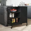 A black kitchen cart is shown in a kitchen setting next to cabinets and a sink. Podgląd zdjęcia produktu