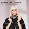 A woman holds a hair straightener in front of her. Podgląd zdjęcia produktu