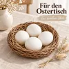 Zwölf ausgeblasene Enteneier mit weißer Schale auf dem Frühlingstisch, in einem flachen Weidennest auf Leinen Produktbild-Vorschau
