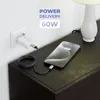 A smartphone is charging on a dark wooden nightstand next to a white lamp. A white power adapter is plugged into a white wall socket, connected to the phone by a black and white braided cable. Produktbild-Vorschau