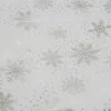 A close-up view of a white tablecloth with a repeating pattern of silver snowflakes and small dots. Náhľad obrázku produktu