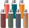 A collection of glass water bottles with silicone sleeves in various colors. Podgląd zdjęcia produktu