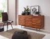 A modern living room setting with a wooden sideboard, a chair, and a rug. Náhled obrázku produktu