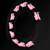 Several pink hula hoop segments arranged in a circular pattern against a black background. Podgląd zdjęcia produktu